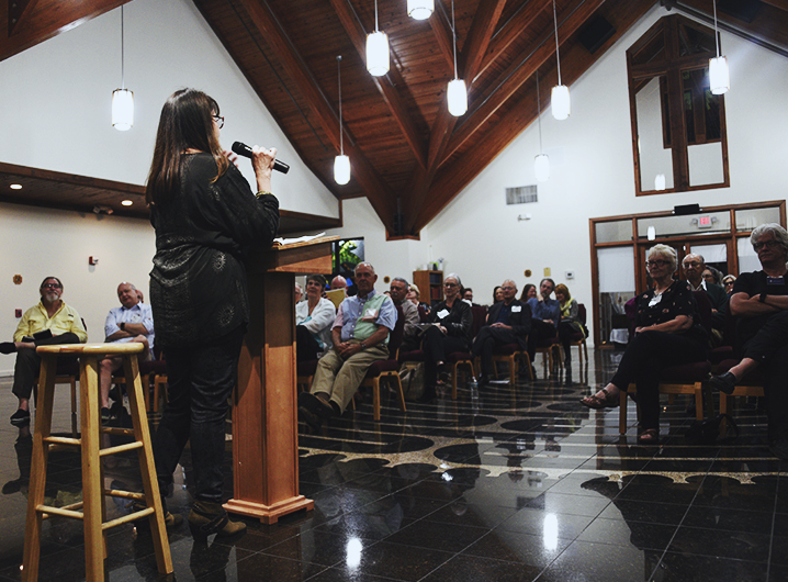 Dr. Constance Avery-Clark giving a presentation at the Center for Jungian Studies of South Florida in front of a full room of people.